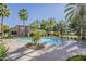 Inviting community pool surrounded by lush landscaping and comfortable lounge chairs, offering a refreshing escape at 3406 E Pyrenees Pass, Phoenix, AZ 85018