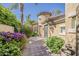 Picturesque single-story home featuring a turret entry, mature landscaping, and a brick-paved walkway at 3406 E Pyrenees Pass, Phoenix, AZ 85018