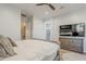 Bright main bedroom featuring wood floors, TV, ceiling fan, and ensuite bathroom with walk in shower at 3406 E Pyrenees Pass, Phoenix, AZ 85018