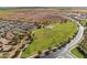 Aerial view of neighborhood featuring green space with walking path and sports courts at 38070 W Frascati Ave, Maricopa, AZ 85138