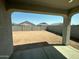 View of backyard surrounded by a tall block wall, offering a secure and private outdoor space at 38070 W Frascati Ave, Maricopa, AZ 85138