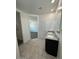 Well-lit bathroom featuring tile floors, a granite-topped vanity, and an ample amount of space at 38070 W Frascati Ave, Maricopa, AZ 85138