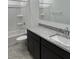 Bright bathroom with a tub-shower, toilet, dark vanity with granite countertops, and a large mirror at 38070 W Frascati Ave, Maricopa, AZ 85138