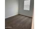 Clean and simple bedroom featuring neutral carpet, walls, window with blinds, and electrical outlets at 38070 W Frascati Ave, Maricopa, AZ 85138