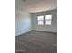 Comfortable bedroom with soft carpeting and dual windows, creating a bright and inviting space at 38070 W Frascati Ave, Maricopa, AZ 85138