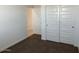 A bedroom with a closet featuring sliding doors and neutral-colored walls and carpet at 38070 W Frascati Ave, Maricopa, AZ 85138