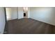 Bedroom featuring neutral carpeting and an open doorway leading to a bathroom at 38070 W Frascati Ave, Maricopa, AZ 85138