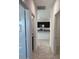 Hallway providing a view of the stylish kitchen with black cabinetry and granite countertops at 38070 W Frascati Ave, Maricopa, AZ 85138
