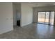 Open-concept living space with tile flooring, modern finishes, and a sliding glass door leading to the backyard at 38070 W Frascati Ave, Maricopa, AZ 85138