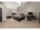 Comfortable bedroom with neutral gray tones, carpet and a convenient work space at 3946 N 112Th Ave, Avondale, AZ 85392