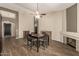 Open-concept dining room featuring elegant dark-stained wood floors and a modern ceiling fan at 3946 N 112Th Ave, Avondale, AZ 85392