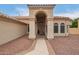 Charming single-story home featuring an arched entryway, tiled roof, and manicured rock landscaping at 3946 N 112Th Ave, Avondale, AZ 85392