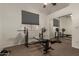 Home gym including weight-lifting bench, racks, machine and a ceiling fan at 3946 N 112Th Ave, Avondale, AZ 85392