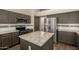 Modern kitchen featuring granite counters, tiled backsplash, stainless steel appliances, and center island at 3946 N 112Th Ave, Avondale, AZ 85392
