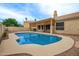 Sparkling pool with ample seating areas, lush landscaping, and a clear blue sky overhead at 3946 N 112Th Ave, Avondale, AZ 85392