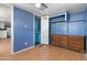 The bedroom features blue walls, laminate flooring, and a closet at 4065 E University Dr # 228, Mesa, AZ 85205