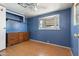 The bedroom features laminate flooring, a fan and a double window at 4065 E University Dr # 228, Mesa, AZ 85205