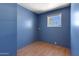 The bedroom showcases laminate flooring, blue walls and a window at 4065 E University Dr # 228, Mesa, AZ 85205