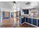 Open floor plan with kitchen, hardwood floors and modern lighting at 4065 E University Dr # 228, Mesa, AZ 85205