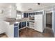 Bright kitchen featuring wood look floors, white appliances, and lots of cabinetry at 4065 E University Dr # 228, Mesa, AZ 85205