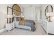 Bright bedroom with a feature headboard, neutral tones, and modern furniture, creating a stylish and comfortable space at 42065 N Cutbow Trl, San Tan Valley, AZ 85140