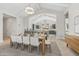 Elegant dining room with open view to kitchen, featuring a wooden table with seating for eight at 42065 N Cutbow Trl, San Tan Valley, AZ 85140