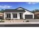 Charming single-story home with a tidy desert-style yard and an attached two-car garage at 42065 N Cutbow Trl, San Tan Valley, AZ 85140