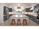 Spacious kitchen with modern grey cabinetry, stainless steel appliances and a large center island at 42065 N Cutbow Trl, San Tan Valley, AZ 85140