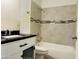 Bathroom featuring a toilet, vanity, and bathtub with tiled walls at 4242 N 69Th Dr # 1303, Phoenix, AZ 85033