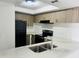 Well-lit kitchen featuring modern stainless steel appliances and white countertops at 4242 N 69Th Dr # 1303, Phoenix, AZ 85033
