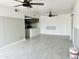 Open living room area with tile flooring and partial kitchen view at 4242 N 69Th Dr # 1303, Phoenix, AZ 85033