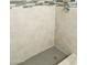 Shower stall featuring decorative tile accents and modern fixtures at 4242 N 69Th Dr # 1303, Phoenix, AZ 85033