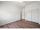 This bedroom features hardwood floors, a closet, and a ceiling fan at 4414 W Monte Way, Laveen, AZ 85339