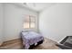 Simple bedroom features hardwood floors, a ceiling fan and a twin bed at 4414 W Monte Way, Laveen, AZ 85339