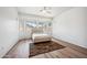 Bright bedroom featuring wood-look floors, a ceiling fan and large windows for ample natural light at 4414 W Monte Way, Laveen, AZ 85339