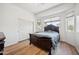 Bedroom with hardwood-style floors, large window, and an oversized dark wood sleigh bed at 4414 W Monte Way, Laveen, AZ 85339