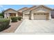 Charming single-story home with a neutral color scheme, well-maintained landscaping, and a spacious three-car garage at 4414 W Monte Way, Laveen, AZ 85339
