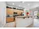 Well-lit kitchen featuring wood cabinets, stainless appliances, granite countertops, a breakfast bar, and tile flooring at 4414 W Monte Way, Laveen, AZ 85339
