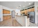 Spacious kitchen featuring ample cabinetry, granite counters, and stainless steel refrigerator at 4414 W Monte Way, Laveen, AZ 85339
