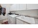 Spacious laundry room with white cabinets, sink and washer/dryer at 4414 W Monte Way, Laveen, AZ 85339