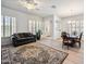 Open-concept living area with hardwood floors, plantation shutters, modern ceiling fan, and a comfortable seating arrangement at 4414 W Monte Way, Laveen, AZ 85339
