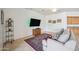 Cozy living room area with mounted TV and wooden cabinet for extra storage at 4414 W Monte Way, Laveen, AZ 85339