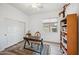 Office featuring light floors, a ceiling fan, and a small desk and chair with a bookcase at 4414 W Monte Way, Laveen, AZ 85339
