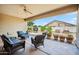 Back patio with comfortable seating and views of the landscaped yard at 4414 W Monte Way, Laveen, AZ 85339