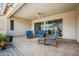 Inviting outdoor patio with comfortable wicker furniture, ceiling fan, and a smooth concrete floor for relaxation at 4414 W Monte Way, Laveen, AZ 85339