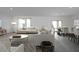 Spacious living room with modern decor, hardwood floors, and dining area at 47220 W Coe St, Maricopa, AZ 85139