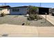 Charming single-story home with desert landscaping and covered parking at 513 S Cardinal Dr, Apache Junction, AZ 85120