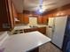 Functional kitchen with wooden cabinets and a breakfast bar at 513 S Cardinal Dr, Apache Junction, AZ 85120