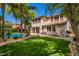 Expansive backyard features a large lawn, refreshing pool, and mature trees at 530 S Emerson St, Chandler, AZ 85225