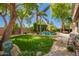 Lush backyard features mature trees, lounge chairs, a swimming pool, and a well-manicured lawn at 530 S Emerson St, Chandler, AZ 85225